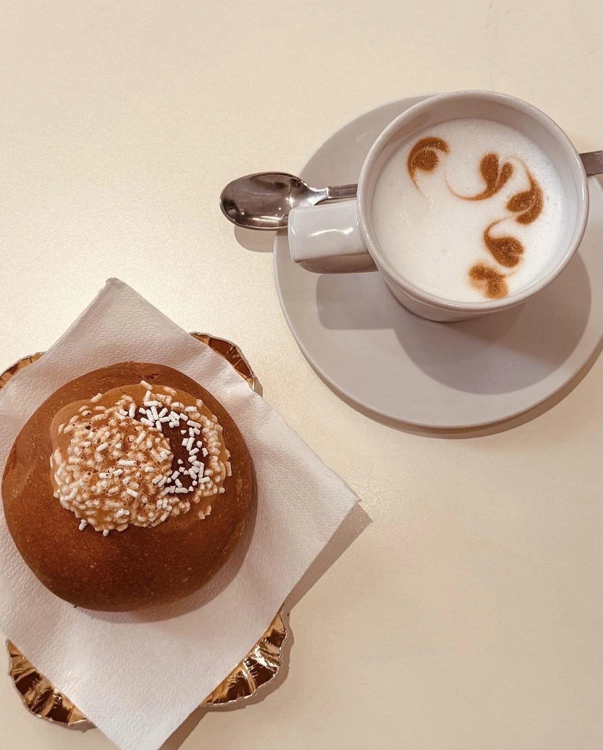 Cappuccino con latte art e brioche del giorno